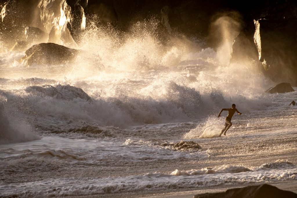 A man riding a wave on top of a surfboard